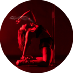 Hayley doing a backbend pose in dark red lighting.