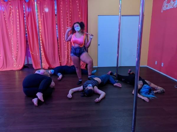 a group of Seattle Pole Dancers perform a pole dance routine